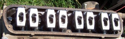 1980 Jeep CJ5 - Close-up of an engine's valve train, showing eight rocker arms with visible '9T' markings.