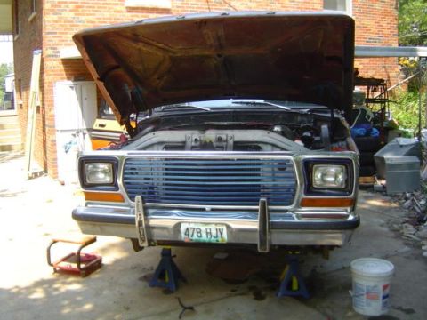 1979 Ford Bronco - Front view of a 1979 Ford Bronco with its hood open, supported by jack stands.