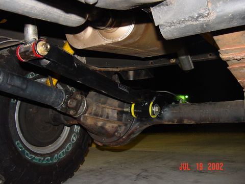 1991 Ford Bronco - Undercarriage view of a vehicle's rear axle and suspension system, showing aftermarket parts.
