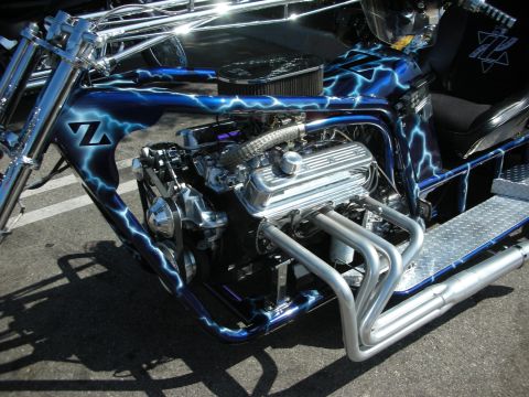 1998 Ford Crown Victoria - A custom trike motorcycle features a V8 engine and striking blue lightning bolt graphics.