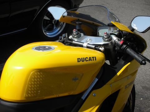 1998 Ford Crown Victoria - Close-up of a yellow Ducati motorcycle's fuel tank and front fairing.