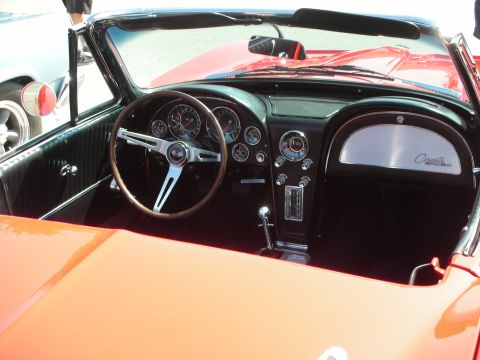 1998 Ford Crown Victoria - The interior of a classic convertible shows a wood-rimmed steering wheel and a dashboard with multiple gauges.