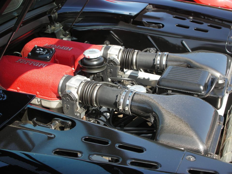 Ferrari engine with red air intakes and carbon fiber intake tubes