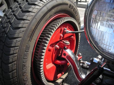 1998 Ford Crown Victoria - A detailed view of a custom wheel assembly and headlight on a vehicle, highlighting unique mechanical components.