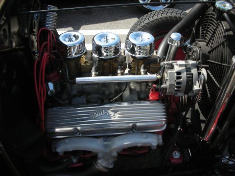 1998 Ford Crown Victoria - Close-up of a custom engine triple carburetors and chrome Edelbrock valve covers.