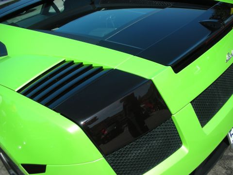 1998 Ford Crown Victoria - This lime green sports car features a distinctive rear design with black accents, including vents and a honeycomb grille.