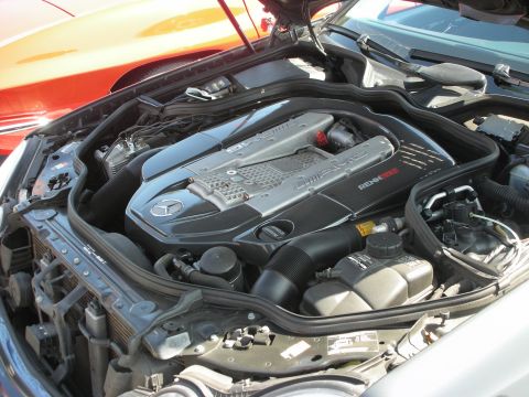 1998 Ford Crown Victoria - The engine bay of a Mercedes-Benz, an AMG engine with Renntech branding visible.