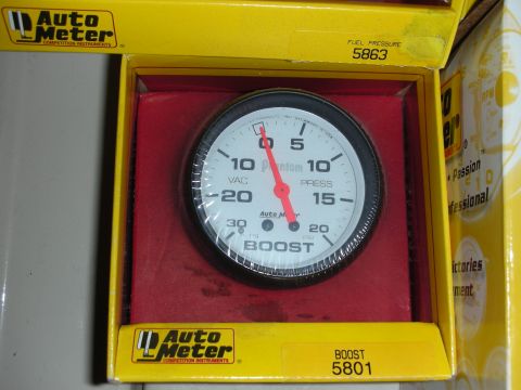 1998 Ford Crown Victoria - A close-up of an Auto Meter boost gauge, indicating its function and brand.