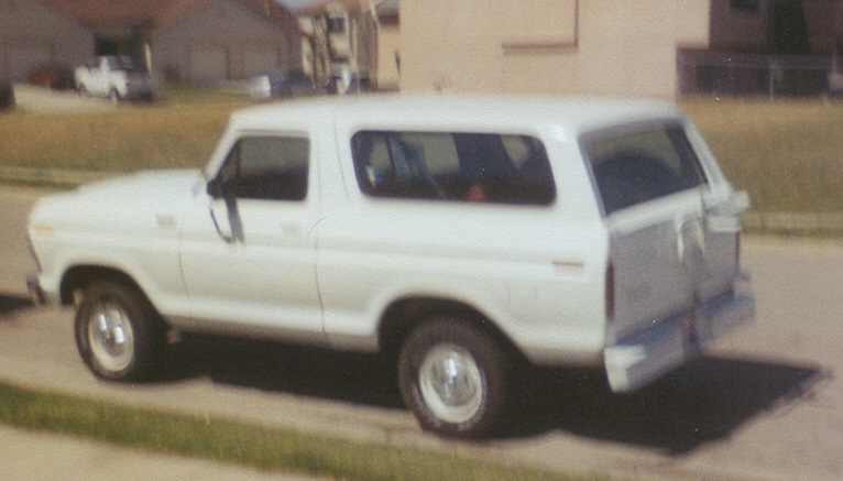 White Ford Bronco SUV viewed from the rear three-quarter on a street