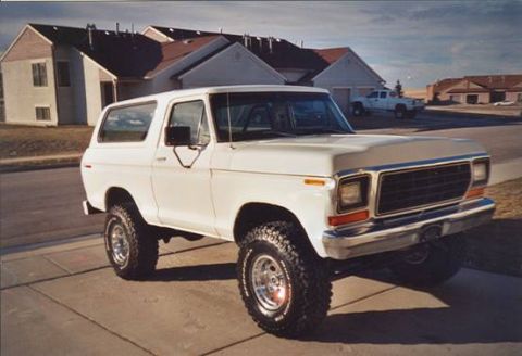 1979 Ford Bronco - This white 1979 Ford Bronco is shown in a 3/4 front view, aftermarket wheels and a prominent grille.