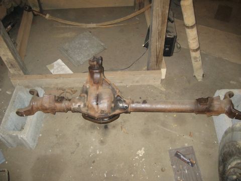1995 Ford Bronco - Rear axle assembly, likely from a truck or SUV, resting on concrete blocks.