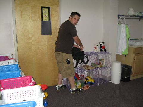 1988 Ford Bronco - A man is seen packing a bag in a room with storage bins and shelves.