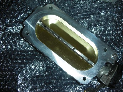 1998 Ford Crown Victoria - A close-up view of a throttle body, a component of the engine's air intake system.