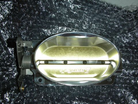 1998 Ford Crown Victoria - Close-up of an Accufab throttle body, a car part, against a black background.