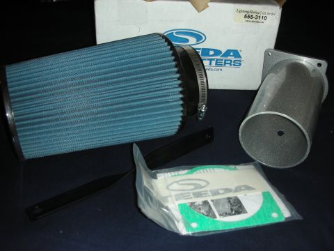 1998 Ford Crown Victoria - K&N cold air intake kit components including filter, tube, and hardware. Box is labeled 'Lightning Harley Cold Air Kit'.