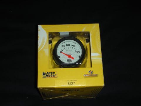 1998 Ford Crown Victoria - An Auto Meter oil pressure gauge is shown inside its retail packaging against a black background.
