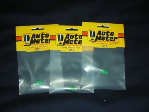 1998 Ford Crown Victoria - Three packages of Auto Meter green LED replacement kits are displayed against a dark background.