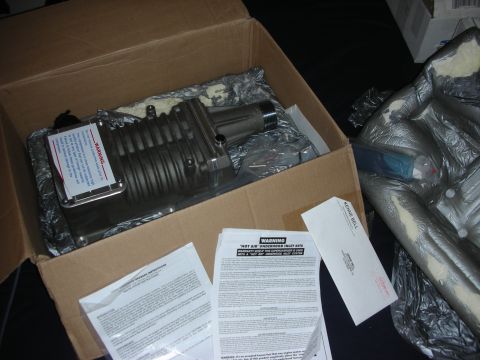 1998 Ford Crown Victoria - New supercharger unit and associated documentation are shown inside a shipping box.