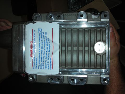 1998 Ford Crown Victoria - A supercharger part is shown with a warning label detailing installation instructions and potential damage.