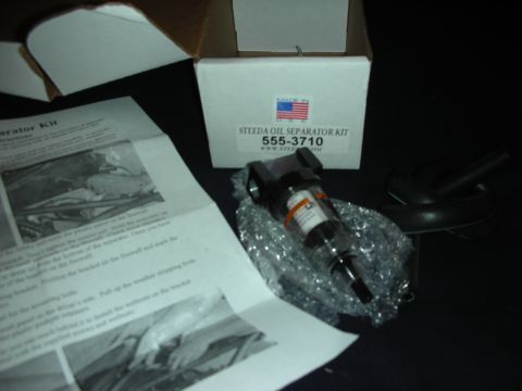 1998 Ford Crown Victoria - A Steeda Oil Separator Kit, part number 555-3710, is shown with its packaging and installation instructions.