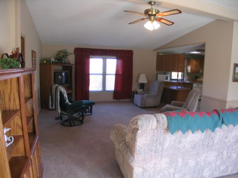 1995 Ford Bronco - Interior view of a living room with furniture and a view into the kitchen.