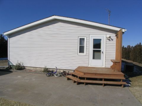 1995 Ford Bronco - A house's exterior is shown with a deck and two bicycles on the ground.