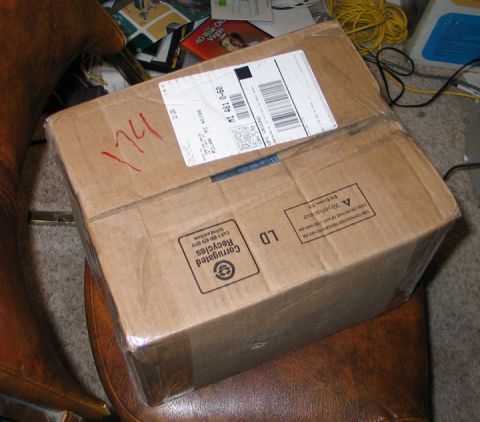 1994 Ford Bronco - A cardboard box sits on a chair, covered in tape and shipping labels.