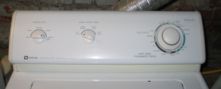 White Maytag washing machine control panel with dials for water level, wash/rinse temp, and cycle selection