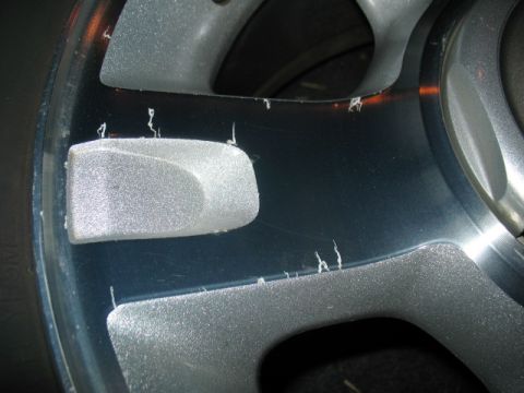 1997 Ford Crown Victoria - The paint on this alloy wheel is chipped and peeling, revealing the metal underneath.