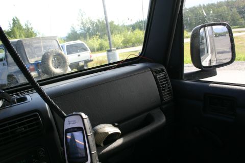 2003 Jeep TJ - View from inside a Jeep Wrangler, with two other vehicles visible through the windows. A handheld GPS unit is mounted on the dashboard.