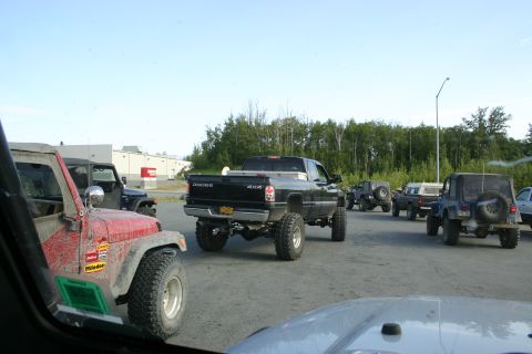 2003 Jeep TJ - A convoy of off-road vehicles, including Jeeps and a Dodge truck, travels together on a sunny day.