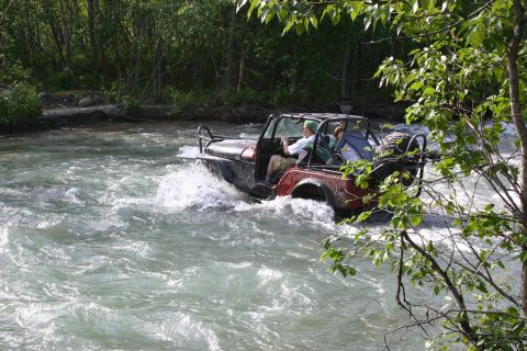 2003 Jeep TJ - This 2003 Jeep TJ navigates a rocky riverbed, kicking up spray.