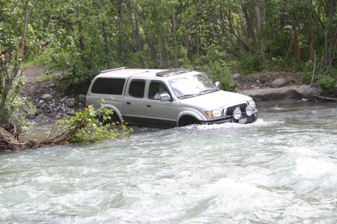 2003 Jeep TJ - Silver 2003 Toyota Tacoma pickup truck navigates a river crossing.