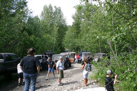 2003 Jeep TJ - A gathering of off-road vehicles and people on a wooded dirt road.