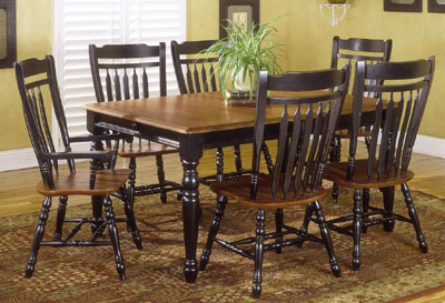 1995 Ford Bronco - A dining set with a wooden table and six chairs is arranged on a patterned rug in a room with yellow walls.