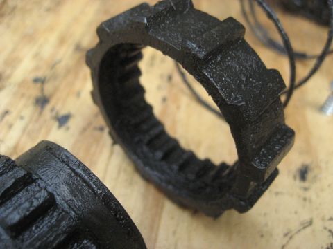 1991 Ford Bronco - Two black, toothed rings, possibly Warn Premium hubs, are shown on a wooden surface.