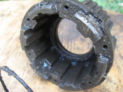1991 Ford Bronco - This image shows a close-up of a worn metal gear housing, likely a component from a vehicle's drivetrain.