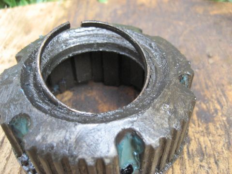 1991 Ford Bronco - Close-up of a greasy Warn Premium hub, showing its internal splines and retaining ring.
