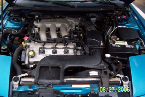 1994 Ford Probe - The engine bay of a car, a V6 engine and blue exterior panels. The date stamp indicates 08/27/2006.