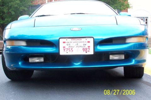 1994 Ford Probe - The front of a teal 1994 Ford Probe is shown, its headlights and license plate.