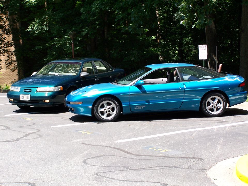 Blue 1994 Ford Probe GT parked next to a dark sedan