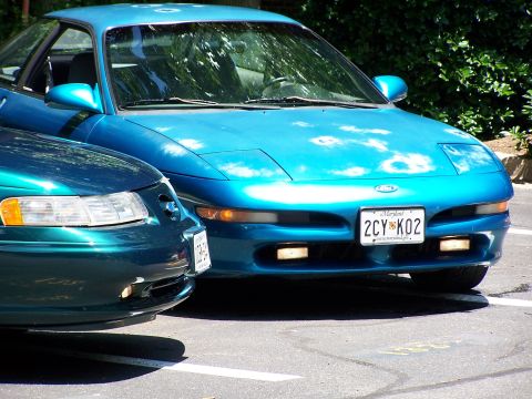 1994 Ford Probe - Front view of a blue 1994 Ford Probe and another car parked together.