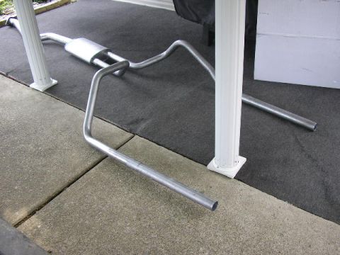 1994 Ford Probe - Exhaust system part shown on the ground, not installed on a vehicle.