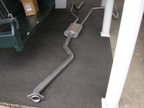 1994 Ford Probe - An exhaust system is shown on a mat, with a box and a bench visible in the background.