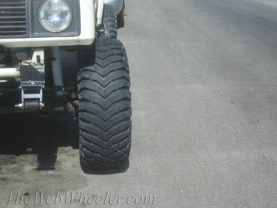 Close-up of a large off-road tire and suspension parts on a vehicle