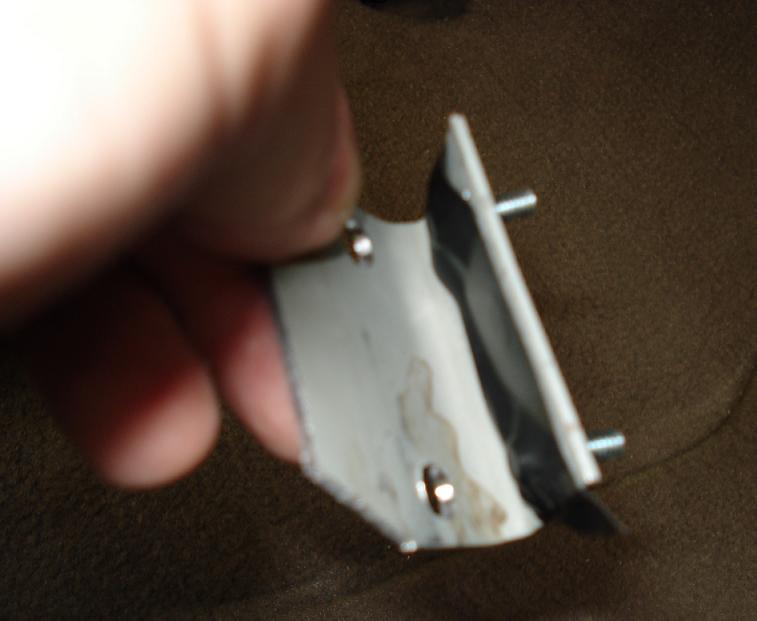 Before mounting the bracket I used tape to hold screws in place while I put the nuts of