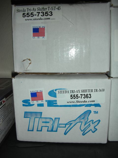 1998 Ford Crown Victoria - Photograph of Steeda Tri-Ax shifter retail boxes showing part numbers, not a technical document.