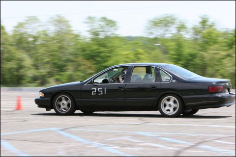 2001 Mercury Grand Marquis - A black sedan with the number 251 on its door navigates a course during an event.