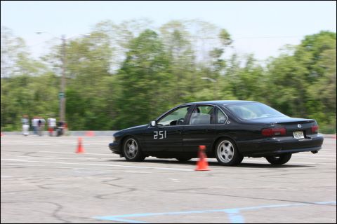 2001 Mercury Grand Marquis - A black sedan, marked with the number 251, navigates an autocross course with traffic cones visible.