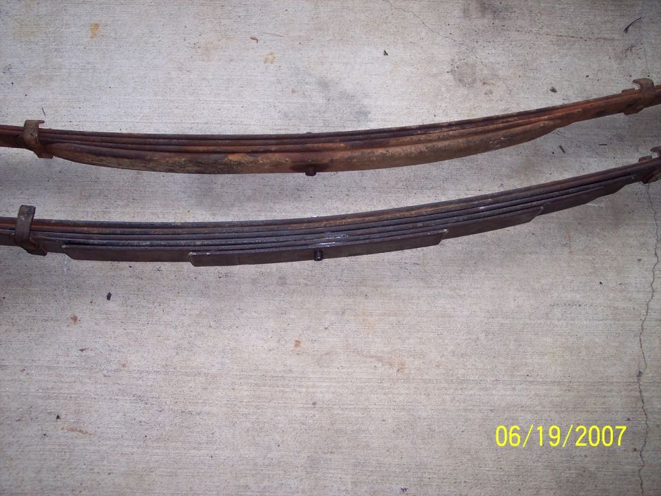 Two rusty leaf springs on a concrete surface. Date stamp reads 06/19/2007